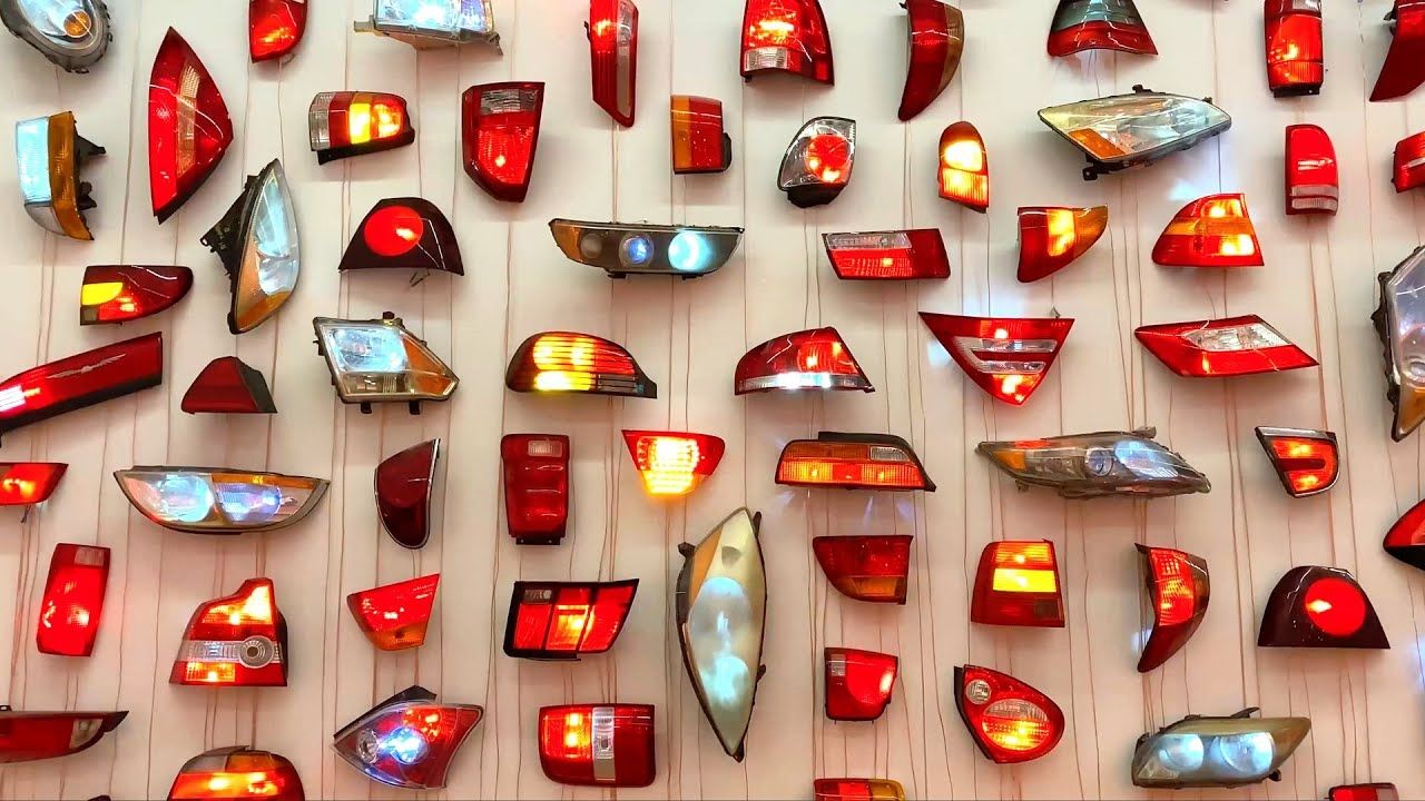 Car head and taillights arranged on a wall