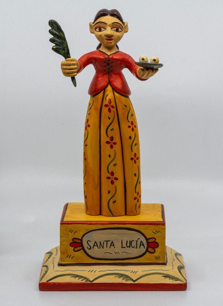 A wooden statue of Santa Lucia, colorful
